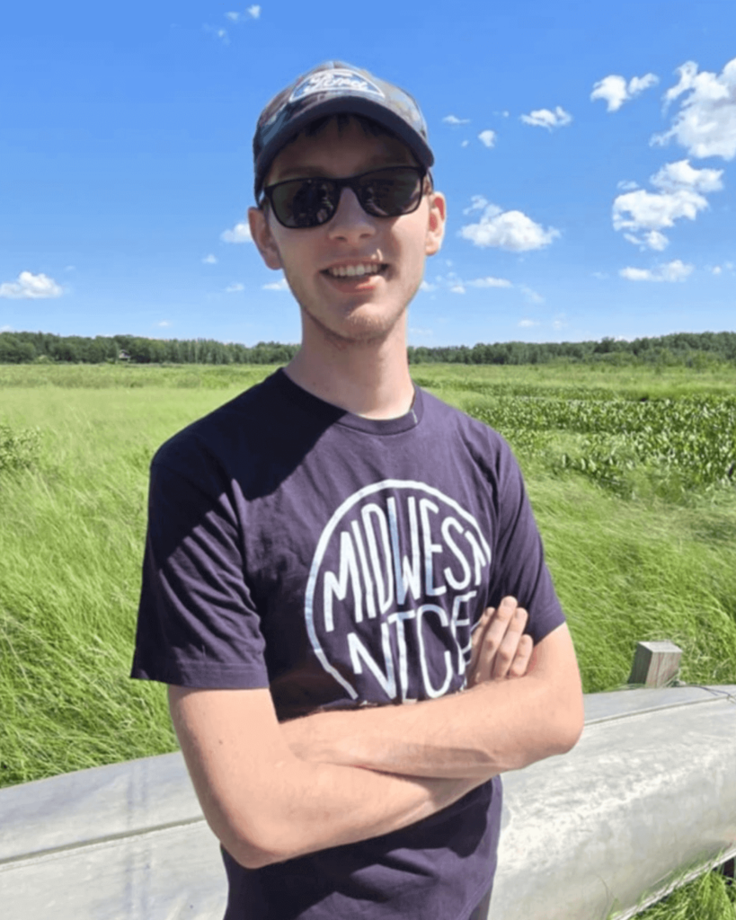 picture of landon on a lush green grass flatland in northern minnesota